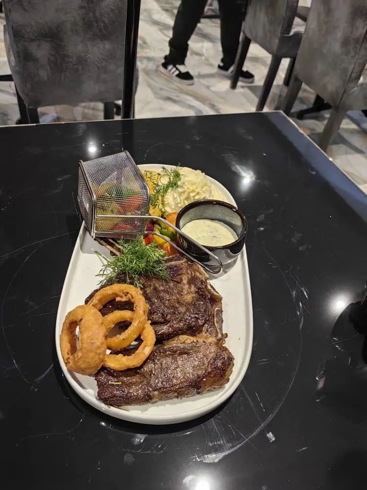 Backspace steak platter with onion rings and creamy mash